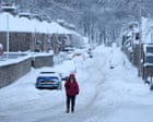 UK weather: schools shut and flights cancelled amid snow and ice warnings – latest updates